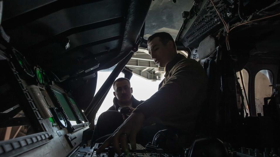 Aviation Electrician's Mate 1st Class Benjamin Healea, right, and Aviation Machinist's Mate 1st Class Eli Davis maintain an MH-60S Knighthawk. (MC2 Nolan Pennington)