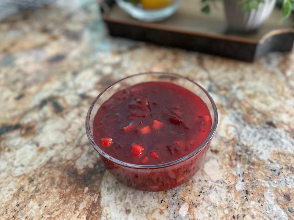 Cranberry sauce in glass container on counter