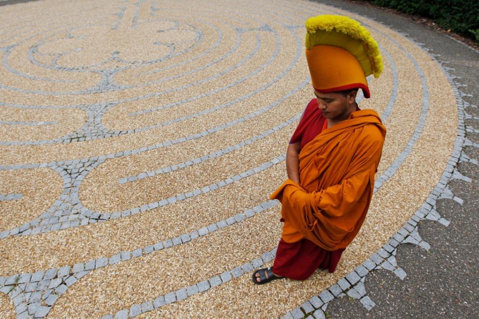 A Buddhist monk from the Tashi Lhunpo Monastery in India walks the Edinburgh Labyrinth in Scotland. REUTERS