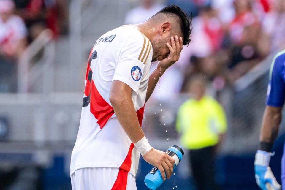 Peru defender Carlos Zambrano (5) sprays water on his face during a water break in the first half of a Copa America match against Canada on Tuesday, June 25, 2024, in Kansas City, Kansas.