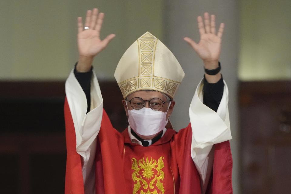 Stephen Chow waves at the episcopal ordination ceremony as the new Bishop of the Catholic Diocese, in Hong Kong, Saturday, Dec. 4, 2021. The new head of Hong Kong's Catholic diocese expressed hope Saturday that he could foster healing in a congregation and a city divided by the continuing fallout from massive anti-government protests in 2019. (AP Photo/Kin Cheung)