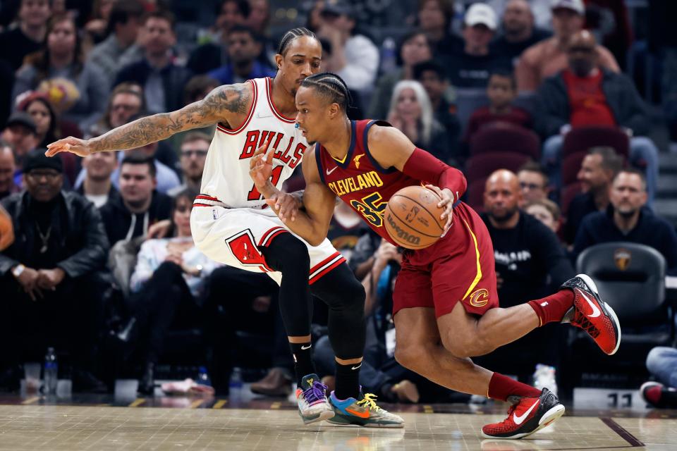 Cavaliers guard Isaac Okoro (35) drives against Chicago Bulls forward DeMar DeRozan (11) during the first half of the Bulls' 98-94 win Saturday night in Cleveland. [Ron Schwane/Associated Press]