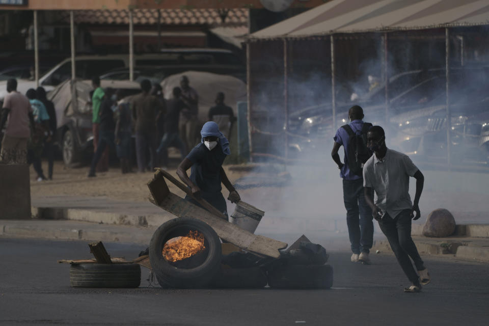 A demonstrator sets up a barricade during a protest in support of main opposition leader Ousmane Sonko in Dakar, Senegal, Monday, May 29, 2023. The clashes came a day after police stopped Sonko's "freedom caravan," traveling from his hometown of Ziguinchor, in the south and where he is the mayor, to the capital, Dakar, where he was forced into a home he has in the city. (AP Photo/Leo Correa)