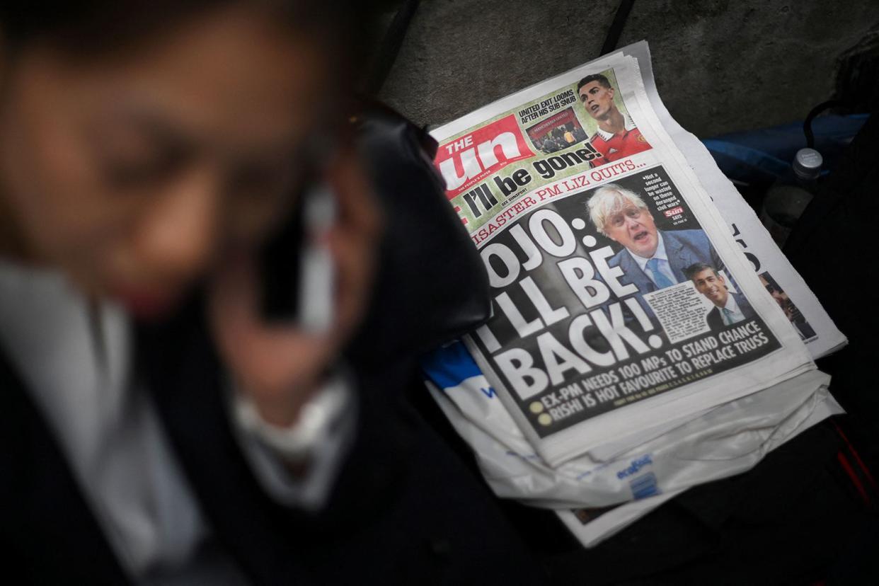 A copy of The Sun newspaper featuring former prime minister Boris Johnson lies on the floor outside 10 Downing Street in central London on Oct. 21, 2022. 