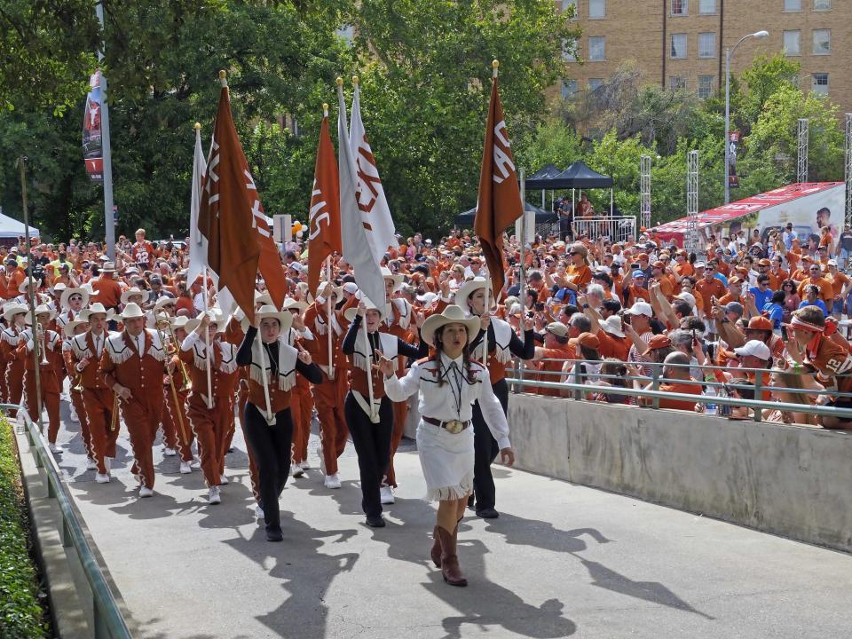 The Texas band marches through a crowd and into Darrell K. Royal-Texas Memorial Stadium before an NCAA college football game against Tulsa, Saturday, Sept. 8, 2018, in Austin, Texas. | Michael Thomas, Associated Press