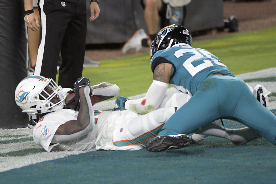 Miami Dolphins wide receiver Preston Williams, left, catches a pass in the end zone for a touchdown as Jacksonville Jaguars strong safety Josh Jones (29) tries to defend during the first half of an NFL football game, Thursday, Sept. 24, 2020, in Jacksonville, Fla. (AP Photo/Phelan M. Ebenhack)