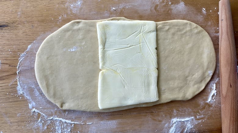 butter square on rolled dough