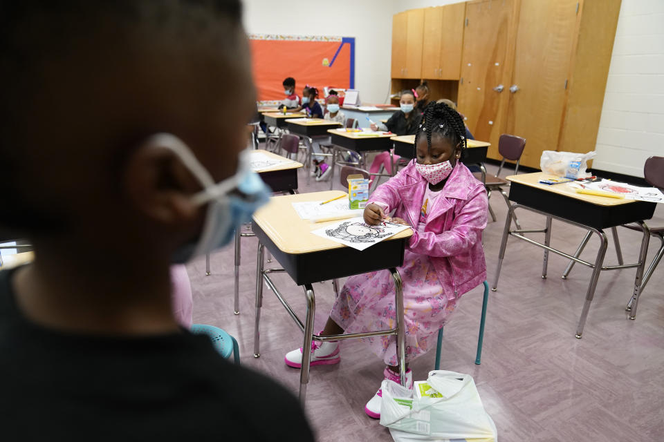 A student colors in a classroom at Tussahaw Elementary school on Wednesday, Aug. 4, 2021, in McDonough, Ga. Schools have begun reopening in the U.S. with most states leaving it up to local schools to decide whether to require masks. (AP Photo/Brynn Anderson)