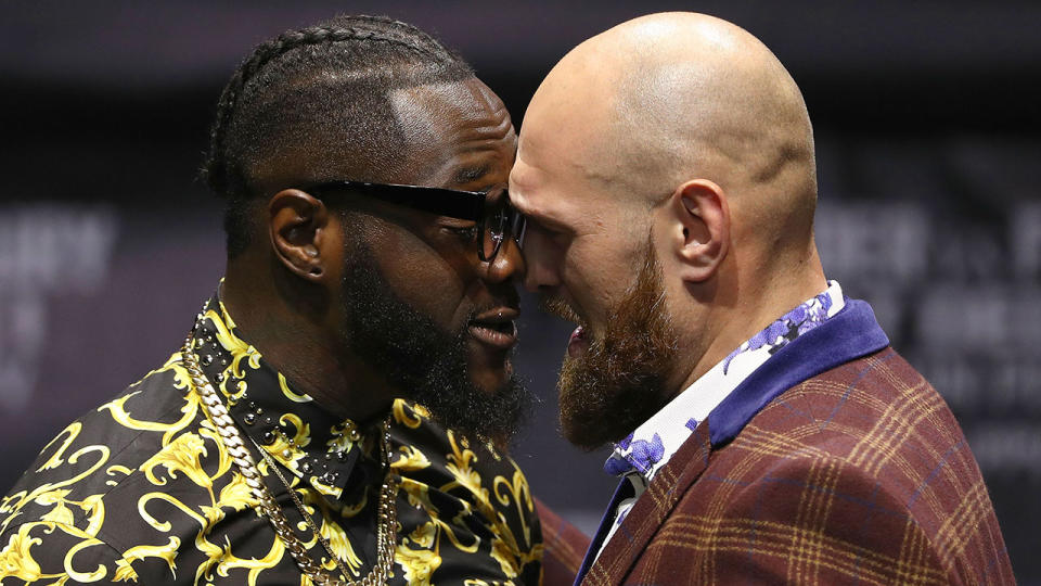 Professional boxers Deontay Wilder (L) and Tyson Fury butt heads onstage during a press conference to promote their upcoming December 1, 2018 fight in Los Angeles at The Novo by Microsoft on October 3, 2018 in Los Angeles, California. (Photo by Victor Decolongon/Getty Images)