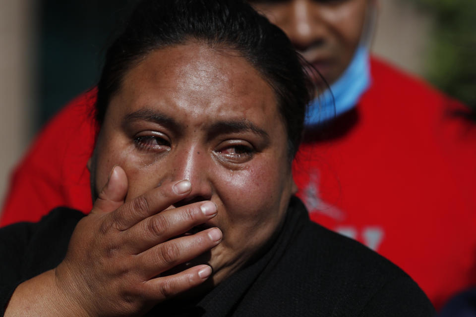 Gabriela Gomez cries after her sister Rosa Gomez was killed at the scene where police chief Omar García Harfuch was attacked by gunmen in Mexico City, Friday, June 26, 2020. Heavily armed gunmen attacked and wounded Mexico City's police chief in an operation that left several people dead. (AP Photo/Rebecca Blackwell)