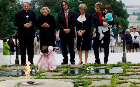  Robert F. Kennedy's granddaughter Saoirse Kennedy Hill places a white rose at the Eternal Flame, President John F. Kennedy's gravesite - Credit: AP