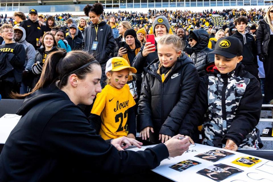 Iowa guard Caitlin Clark (22) signs autographs after the Crossover at Kinnick women’s basketball scrimmage between Iowa and DePaul on Oct. 15 at Kinnick Stadium in Iowa City, Iowa. Joseph Cress/For the Register/Joseph Cress/For the Register / USA TODAY NETWORK