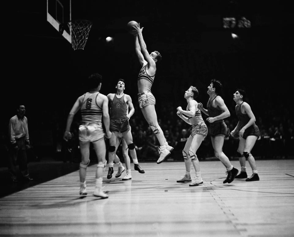 Retrieving a rebound from the board, Bob Doll (5) of the Colorado University quintet, leaps high into the air during play in the championship round of the NIT at Madison Square Garden in New York, March 15, 1940. (AP Photo/Anthony Camerano)