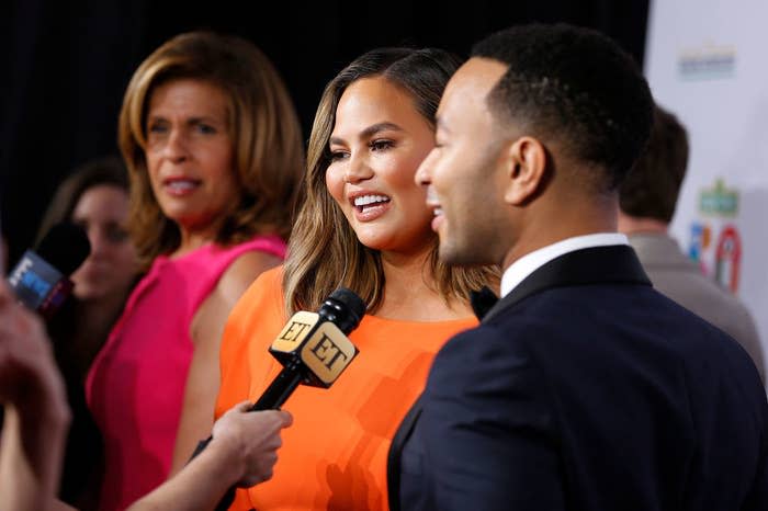 From left to right, Hoda, Chrissy, and John Legend, standing off camera is an Entertainment Tonight reporter, in the background is also an E! News microphone