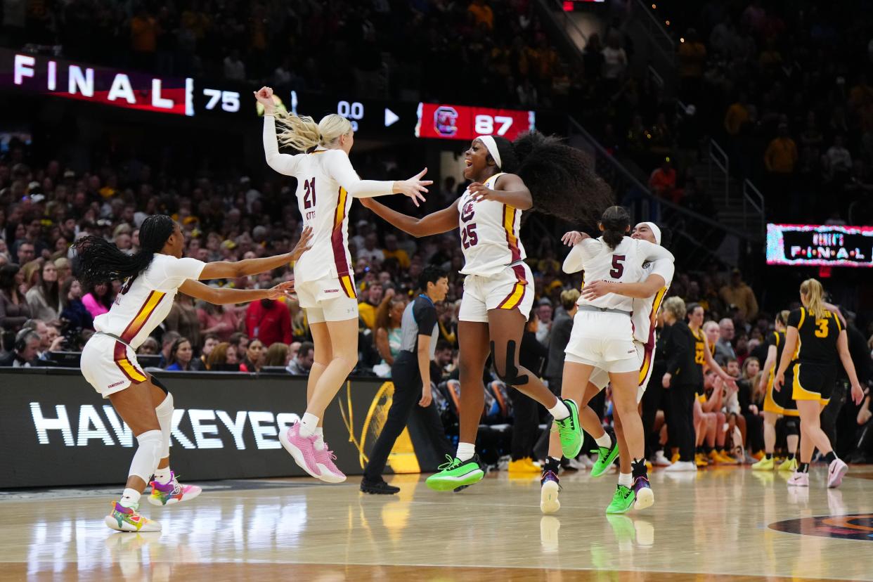 South Carolina guard Raven Johnson (25), forward Chloe Kitts (21) and guard Bree Hall (23) celebrate after the Gamecocks defeated the Iowa Hawkeyes to win the 2024 NCAA women's basketball championship.