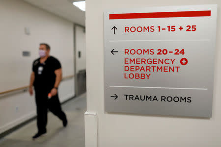 Emergency room nurse Richard Horner wears a mask as he deals with flu patients at Palomar Medical Center in Escondido, California, U.S., January 18, 2018. REUTERS/Mike Blake