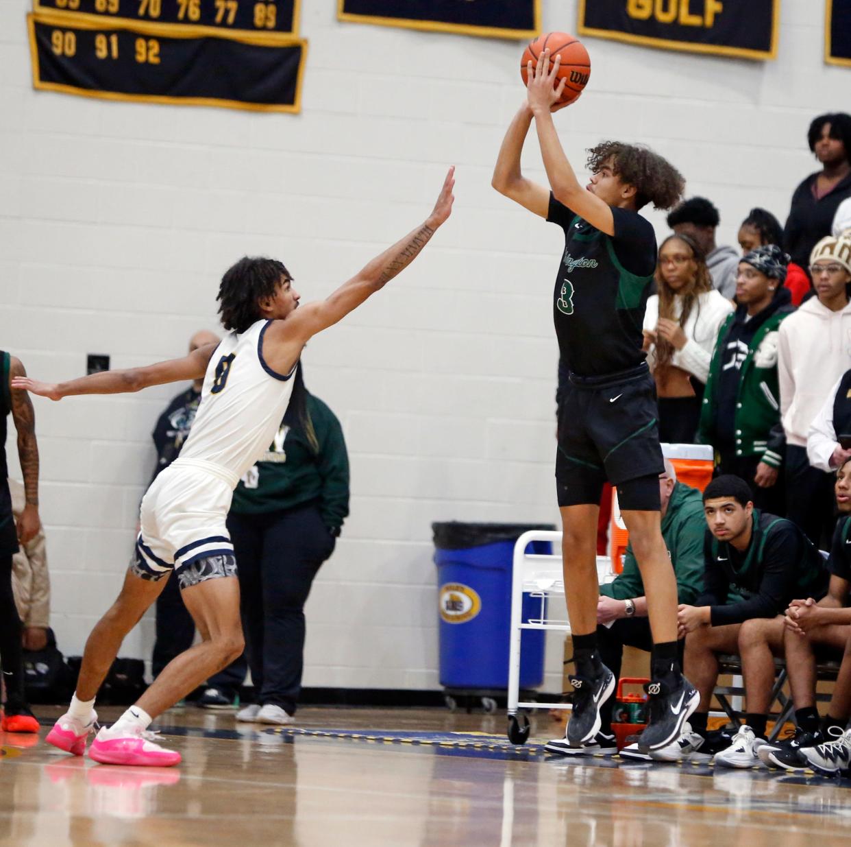 South Bend Washington sophomore Steven Reynolds III, right, shoots a '3' over South Bend Riley senior Payton Baird during a boys basketball game Thursday, Feb. 1, 2024, at Riley High School.