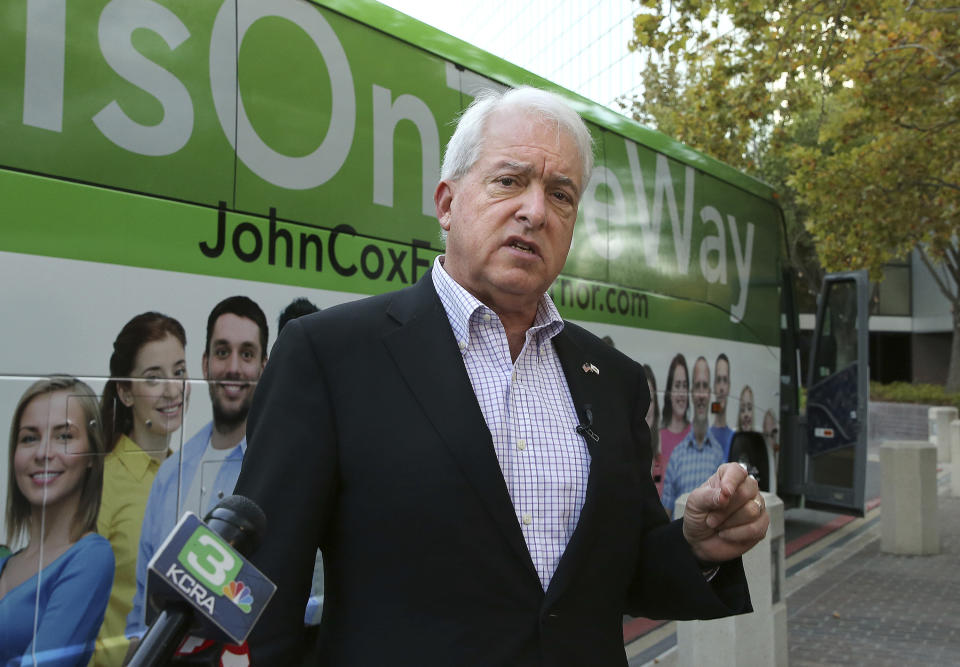 FILE - In this Nov. 1, 2018, file photo, Republican gubernatorial candidate John Cox talks to reporters before beginning a statewide bus tour in Sacramento, Calif. A fading coronavirus crisis and an astounding windfall of tax dollars have reshuffled California's emerging recall election, allowing Democratic Gov. Gavin Newsom to talk of a mask-free future and propose billions in new spending for schools and businesses as he looks to fend off Republicans who depict him as a foppish failure. (AP Photo/Rich Pedroncelli, File)