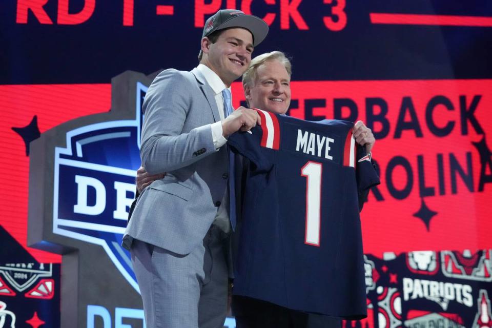 Former UNC quarterback Drake Maye poses with NFL commissioner Roger Goodell after being selected by the <a class="link " href="https://sports.yahoo.com/nfl/teams/new-england/" data-i13n="sec:content-canvas;subsec:anchor_text;elm:context_link" data-ylk="slk:New England Patriots;sec:content-canvas;subsec:anchor_text;elm:context_link;itc:0">New England Patriots</a> as the No. 3 pick in the first round of the 2024 NFL Draft on Thursday night in Detroit. Kirby Lee/Kirby Lee-USA TODAY Sports