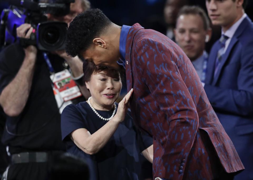 Japan's Rui Hachimura, of Gonzaga, hugs loved ones after the Washington Wizards selected him as the ninth pick overall in the NBA basketball draft Thursday, June 20, 2019, in New York. (AP Photo/Julio Cortez)