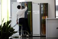 A sales assistant of Samsung Electronics works at its store in Seoul