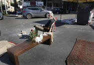 An anti-government protester sits in the middle of a clocked main highway which was blocked for more then ten days during ongoing protests against the Lebanese government, in Beirut, Lebanon, Wednesday, Oct. 30, 2019. Lebanese banks have been closed for the last two weeks as the government grapples with mass demonstrations that have paralyzed the country, but an even greater crisis may set in when they reopen Friday. (AP Photo/Hussein Malla)