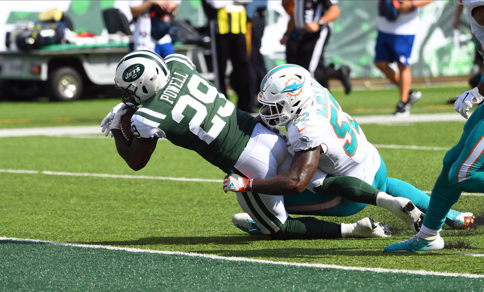 Sep 16, 2018; East Rutherford, NJ, USA;  New York Jets running back Bilal Powell (29) scores a second half touchdown as Miami Dolphins linebacker Raekwon McMillan (52) defends at MetLife Stadium. Mandatory Credit: Robert Deutsch-USA TODAY Sports