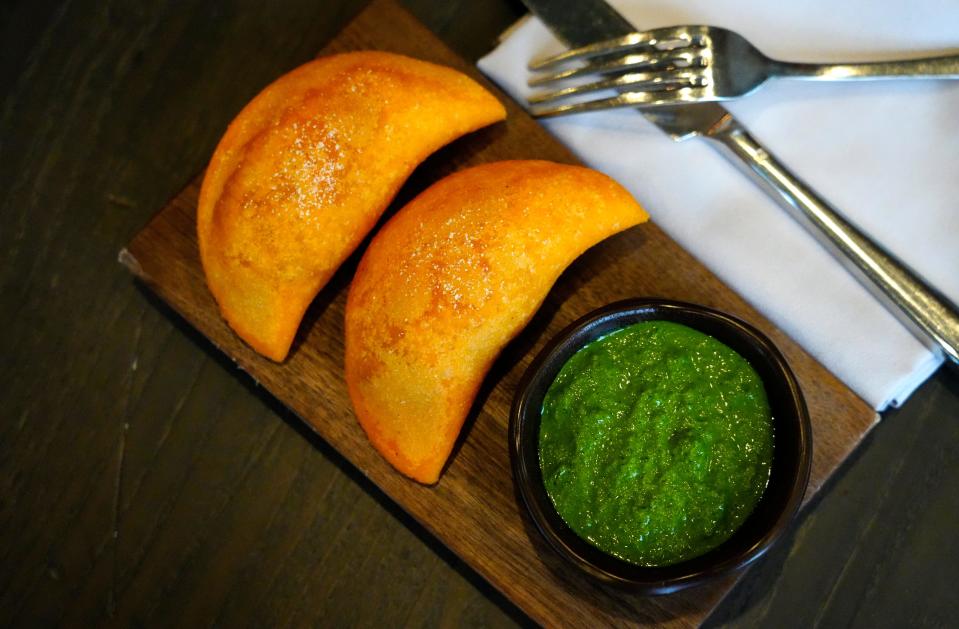 The empanadas de res con pique, one of the tapas dishes served at Mita's. These are filled with beef short ribs and served with a cilantro-chili sauce.