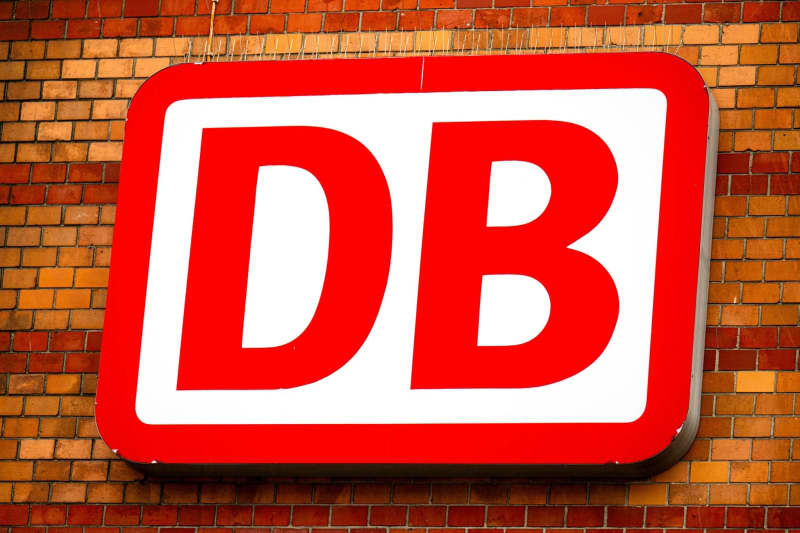 A sign with the Deutsche Bahn (DB) logo lights up at Bremen Central Station. Deutsche Bahn (DB), Germany's state-owned rail operator, is making good progress with its small and medium-scale construction projects and will have 40% of them complete by the end of 2025 at a cost of some €1 billion ($1.1 billion). Sina Schuldt/dpa