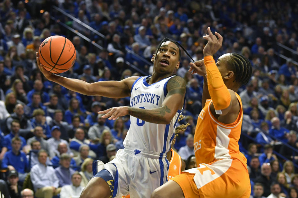 Kentucky guard Rob Dillingham (0) goes up for a layup over Tennessee guard Jordan Gainey (2) during the second half of an NCAA college basketball game in Lexington, Ky., Saturday, Feb. 3, 2024. Tennessee won 103-92. (AP Photo/Timothy D. Easley)