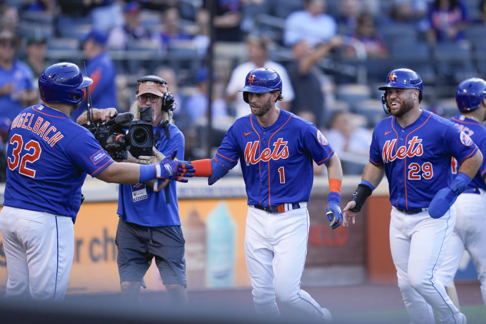 New York Mets' Jeff McNeil (1), center, and DJ Stewart (29), right, are greeted by Daniel Vogelbach (32), left, after McNeil hit a two-run homer during the fifth inning of a baseball game against the Arizona Diamondbacks at Citi Field, Thursday, Sept. 14, 2023, in New York. (AP Photo/Seth Wenig)