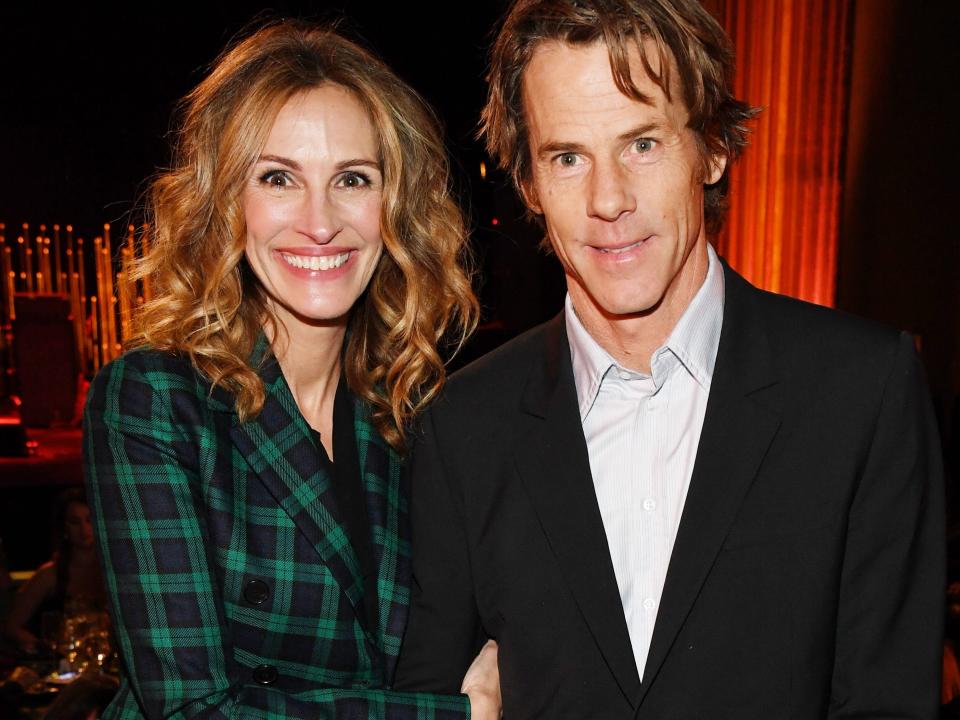 Julia Roberts wears a green plaid suit and poses next to husband Daniel Moder.