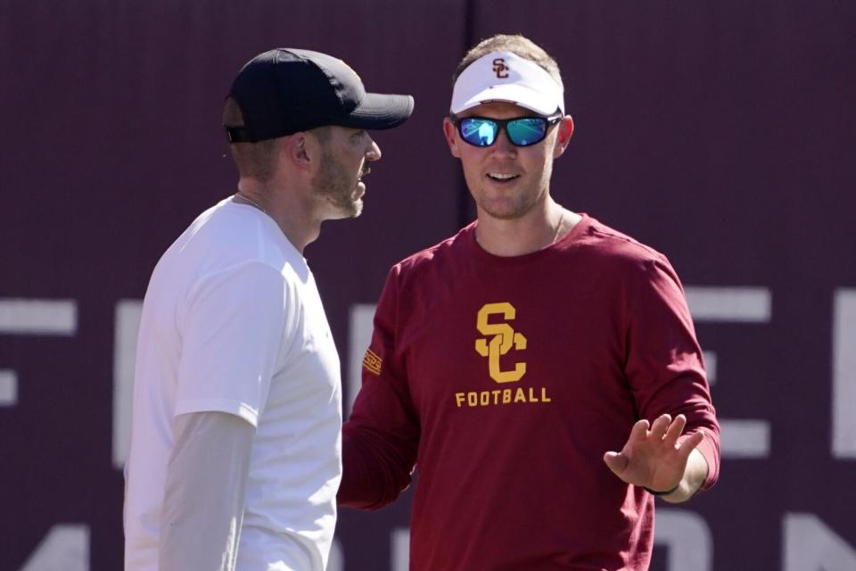 USC coach Lincoln Riley, left, talks with defensive coordinator Alex Grinch during practice in March.