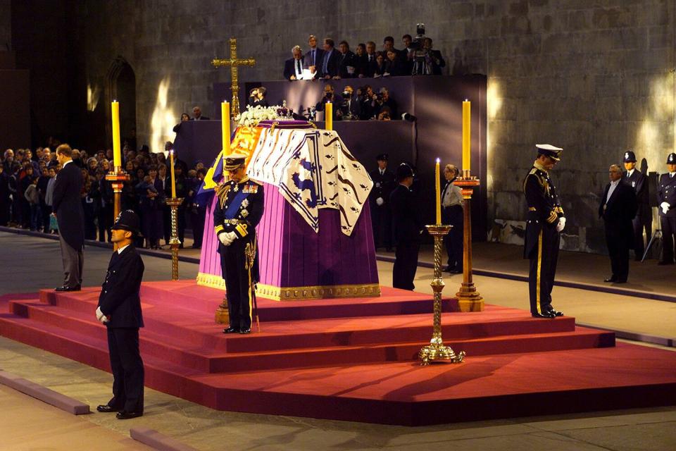 Prince Charles of Britain stands in vigil at the coffin of his grandmother the Queen Mother as it lies in state April 8, 2002 in Westminster Hall, London