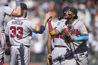 Atlanta Braves pitcher A.J. Minter (33) celebrates with right fielder Ronald Acuna Jr. after the Braves defeated the San Francisco Giants in a baseball game in San Francisco, Saturday, Aug. 26, 2023. (AP Photo/Jeff Chiu)