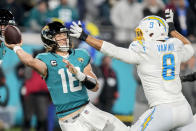 Jacksonville Jaguars quarterback Trevor Lawrence (16) tries to throw a pass under pressure by Los Angeles Chargers linebacker Kyle Van Noy (8) during the second half of an NFL wild-card football game, Saturday, Jan. 14, 2023, in Jacksonville, Fla. (AP Photo/John Raoux)