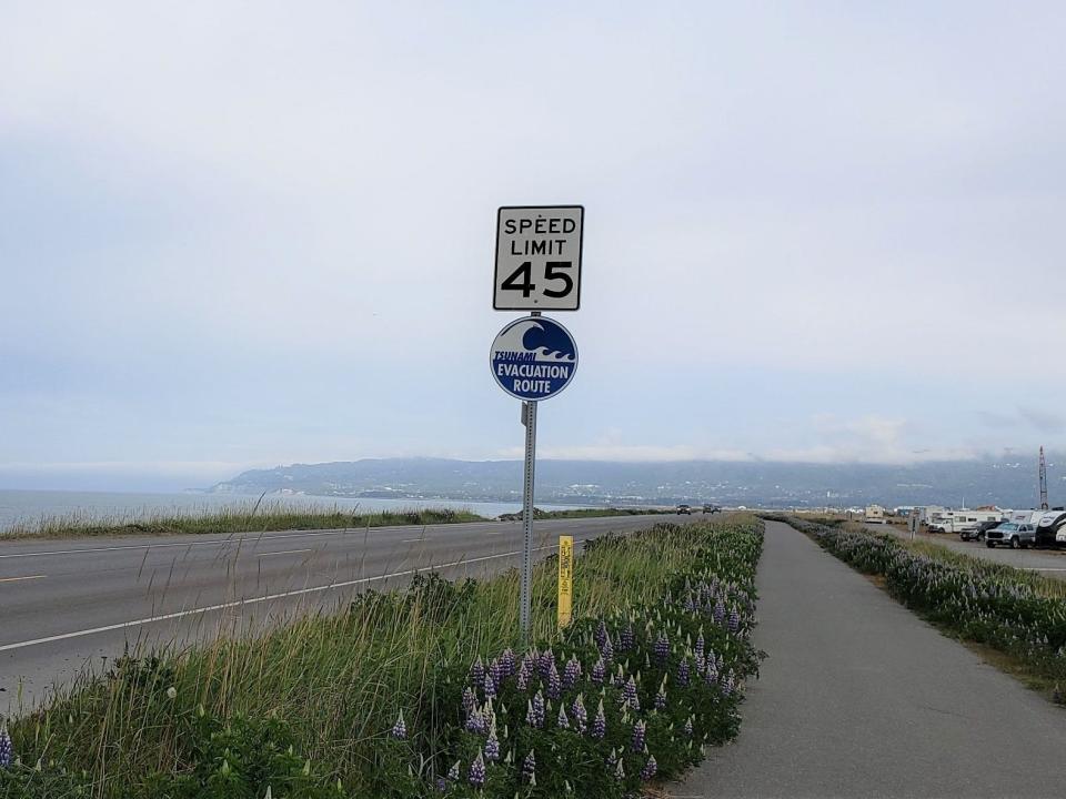 Alaska speed limit sign with tsunami warning sign