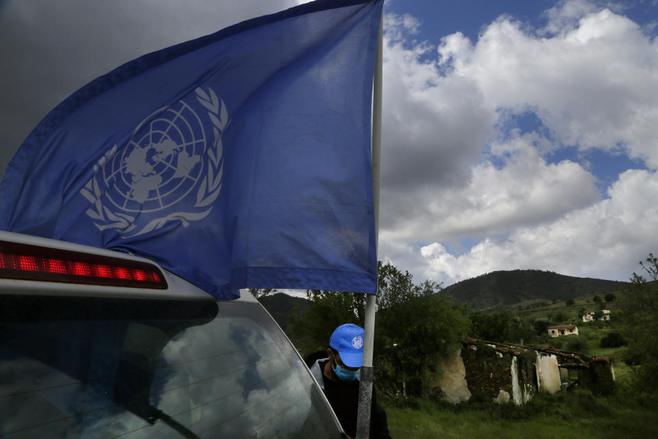 A U.N vehicle with a U.N flag is seen inside the U.N controlled buffer zone that divide the Greek, south, and the Turkish, north, Cypriot areas since the 1974 Turkish invasion, Cyprus, on Friday, March 26, 2021. Cyprus' endangered Mouflon sheep is one of many rare plant and animal species that have flourished a inside U.N. buffer zone that cuts across the ethnically cleaved Mediterranean island nation. Devoid of humans since a 1974 war that spawned the country’s division, this no-man's land has become an unofficial wildlife reserve. (AP Photo/Petros Karadjias)