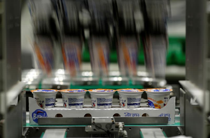 A robotic arm sorts yogurts at a distribution centre near Prague