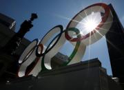 Summer sunshine is seen through Olympic rings displayed at Nihonbashi district in Tokyo, Japan