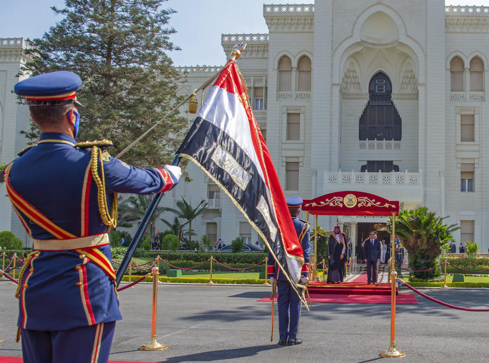 In this photo released by the Saudi Royal Palace, Saudi Crown Prince Mohammed bin Salman and Egyptian President Abdel-Fattah el-Sissi review an honor guard, in Cairo, Egypt, Tuesday, June 21, 2022. (Bandar Aljaloud/Saudi Royal Palace via AP)