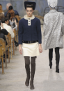 Chanel AW13 Couture: This navy buttoned up coat was teamed with a white mini skirt and brown boots.