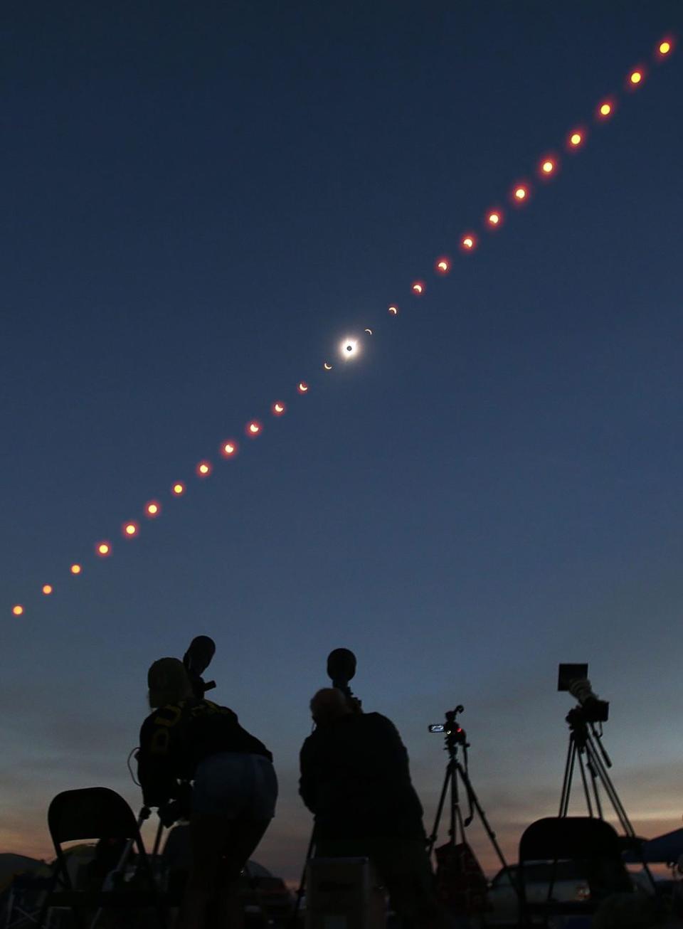 Photographers make images of the 2017 total eclipse over Madras in this four hour time-lapse composite image.