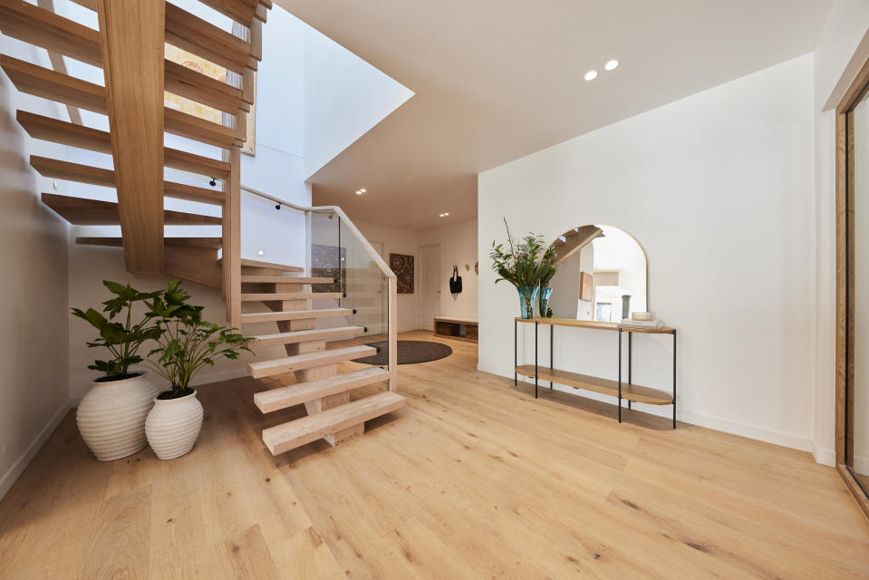 A shot of the staircase on the left and a mirror on the right. 