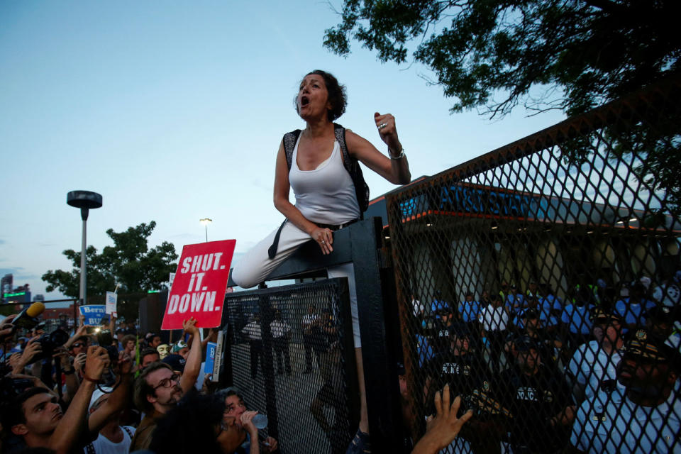 <p>A supporter of Senator Bernie Sanders shouts “election fraud” as she scales the parimeter walls before being arrested at the 2016 Democratic National Convention in Philadelphia, Pennsylvania, July 26, 2016. R (Photo: Adrees Latif/Reuters)</p>