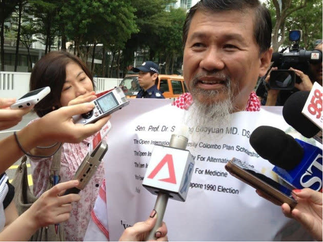 Zeng dons a 'bib' detailing the 'injustices' done to him