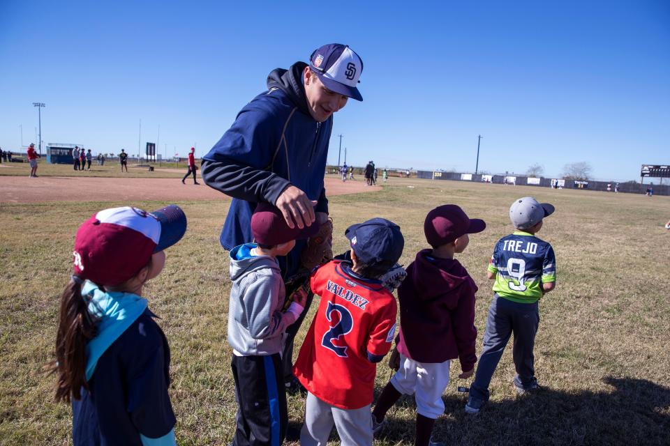 San Diego Padres minor leaguer Michael Cantu talks with kids during a 2018 toy drive at Corpus Christi John Paul II High School.