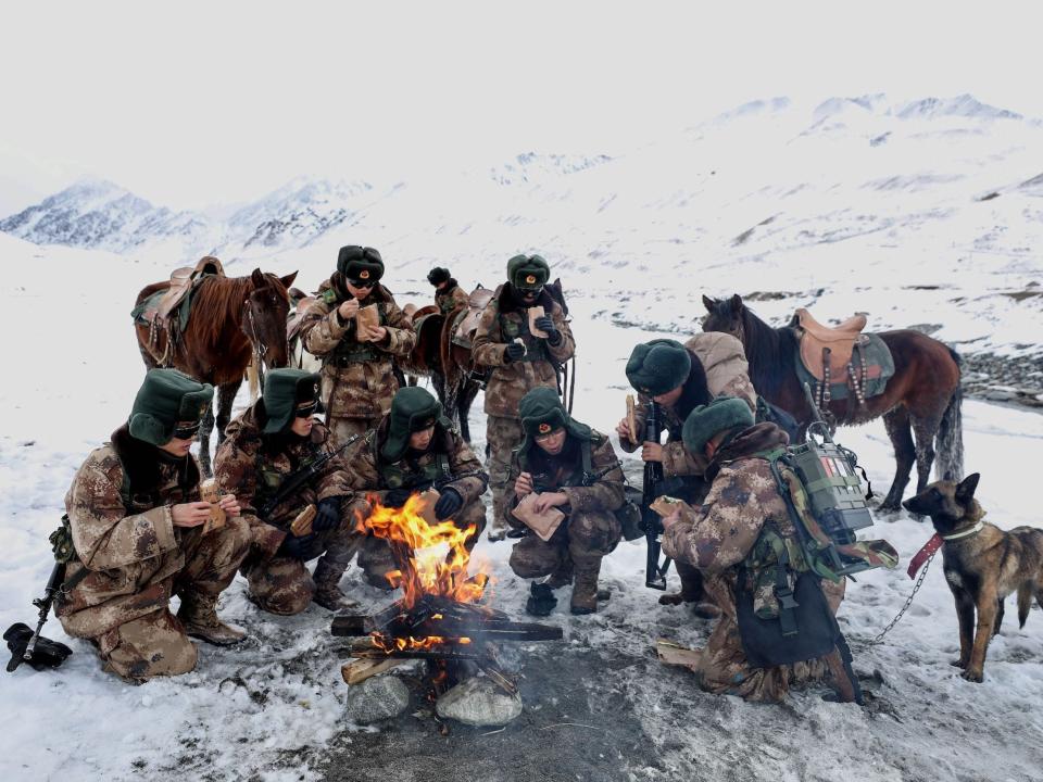 Chinese People's Liberation Army soldiers eating as they patrol along the border of Khunjerab Pass in Kashgar in China's western Xinjiang region.