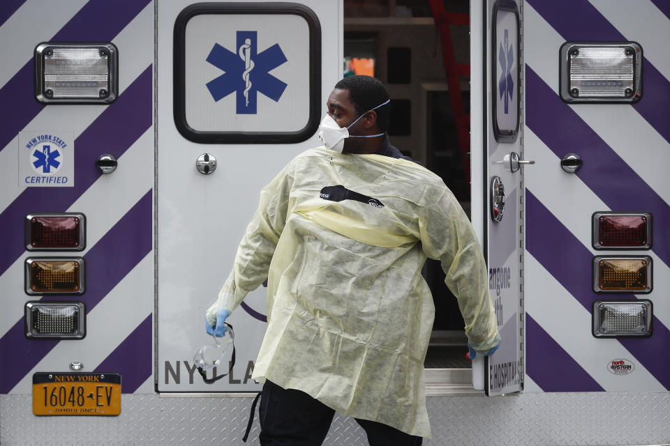An emergency medical worker arrives at Cobble Hill Health Center, Friday, April 17, 2020, in the Brooklyn borough of New York. The despair wrought on nursing homes by the coronavirus was laid bare Friday in a state survey identifying numerous New York facilities where multiple patients have died. (AP Photo/John Minchillo)