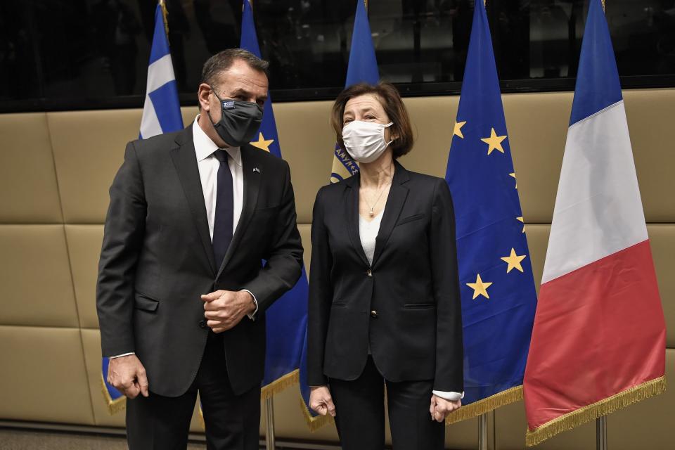 French Defense Minister Florence Parly, right, and his Greek counterpart Nikos Panagiotopoulos speak during their meeting in Athens, Monday, Jan. 25, 2021. Greece is due to sign a 2.3 billion euro ($2.8 billion) deal with France Monday to purchase 18 Rafale fighter jets to address tension with neighbor Turkey. (Louisa Gouliamaki/Pool via AP)